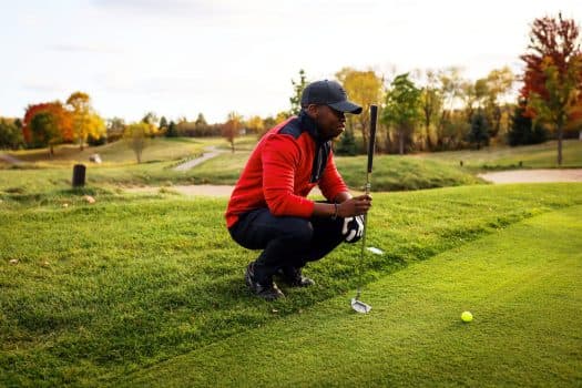 Networking scene on the clubhouse patio, drinks in hand, deals in motion